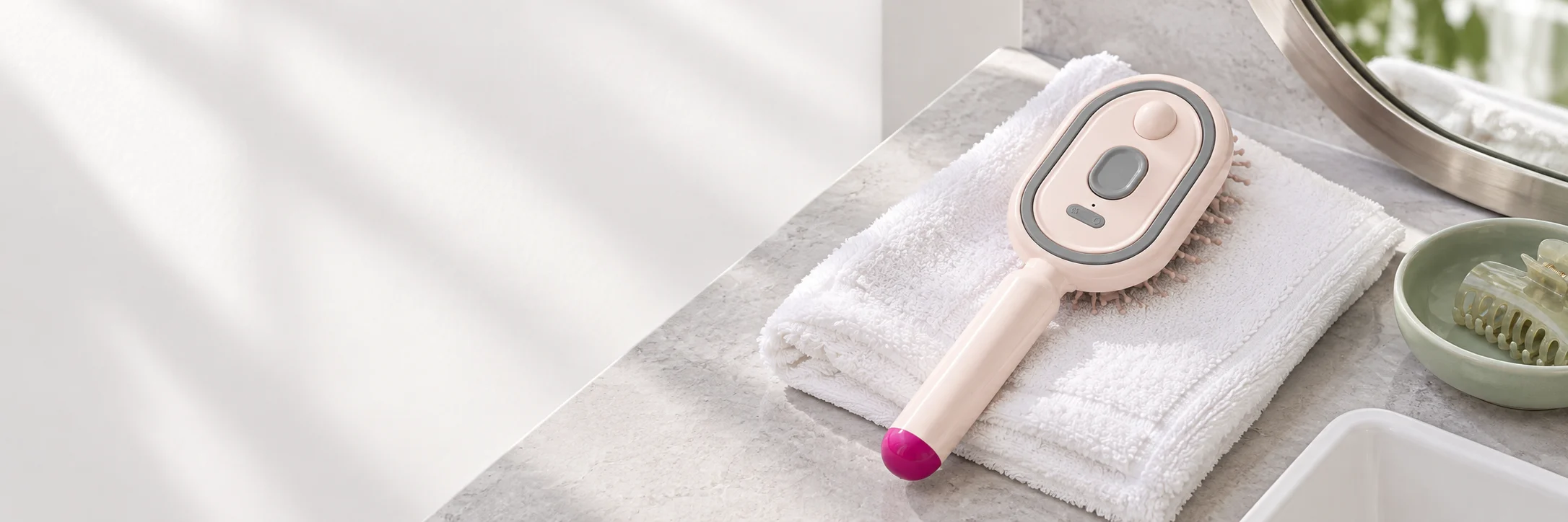 Hair care comb on a towel beside a bathroom mirror